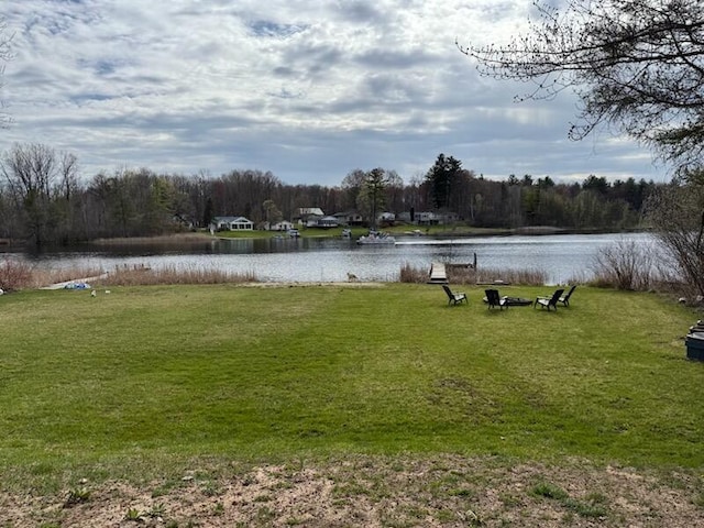 4605 Hunters Trl, Six Lakes, MI 48886 - view of green lawn with a water view