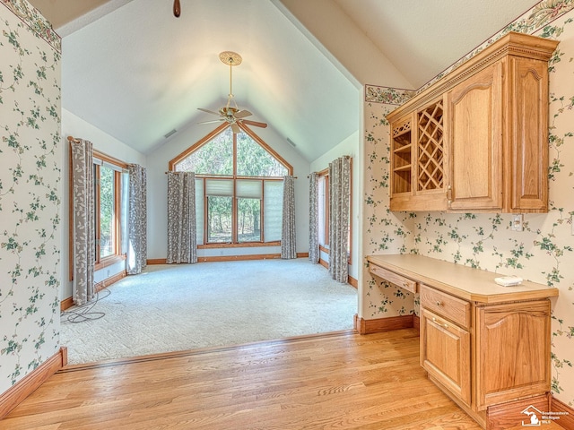 3158 Lennox Ct, Lambertville, MI 48144 - kitchen with light wood finished floors, vaulted ceiling, a ceiling fan, light countertops, and wallpapered walls