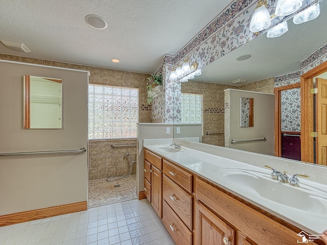 3158 Lennox Ct, Lambertville, MI 48144 - full bath featuring a textured ceiling, walk in shower, tile patterned floors, double vanity, and wallpapered walls