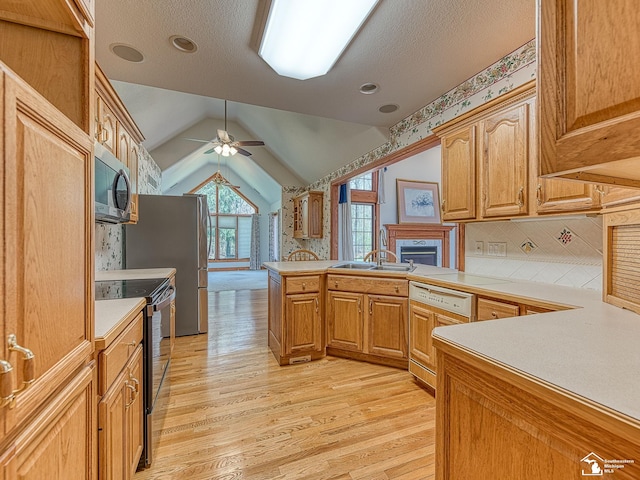 3158 Lennox Ct, Lambertville, MI 48144 - kitchen featuring black electric range, stainless steel microwave, a peninsula, a ceiling fan, and light wood finished floors