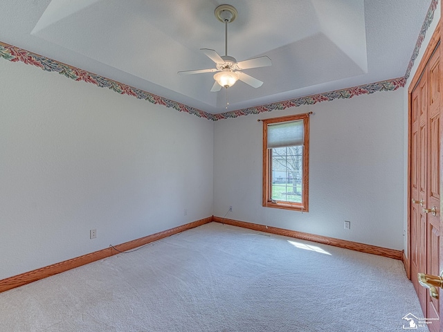 3158 Lennox Ct, Lambertville, MI 48144 - unfurnished room featuring light colored carpet, ceiling fan, baseboards, and a tray ceiling