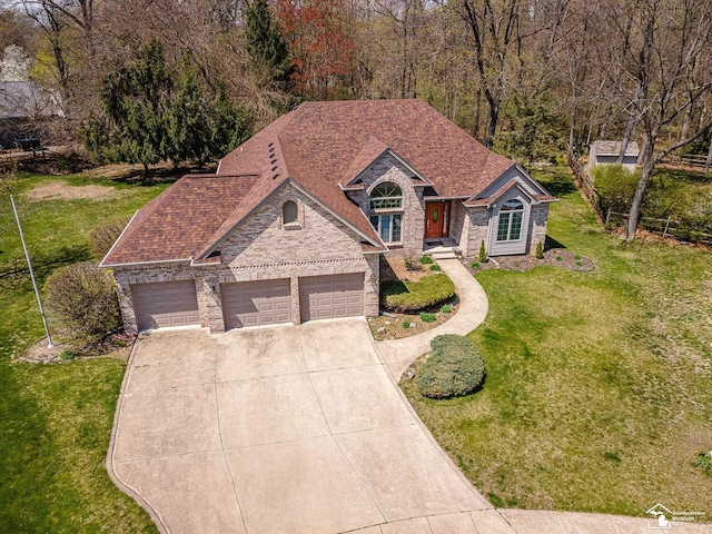 3158 Lennox Ct, Lambertville, MI 48144 - french country inspired facade with driveway, a front lawn, stone siding, an attached garage, and brick siding
