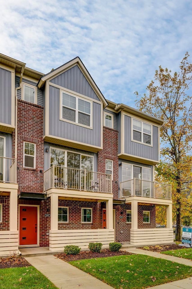 1737 Merrick St # 12, Detroit, MI 48208 - multi unit property with brick siding, board and batten siding, a balcony, and a front yard