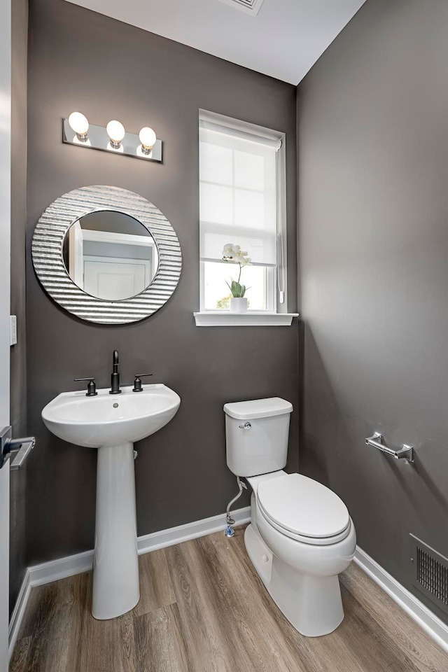 1737 Merrick St # 12, Detroit, MI 48208 - bathroom featuring wood finished floors, baseboards, and toilet