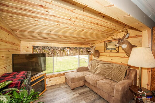 living room with wood ceiling, vaulted ceiling, wood walls, and wood finished floors
