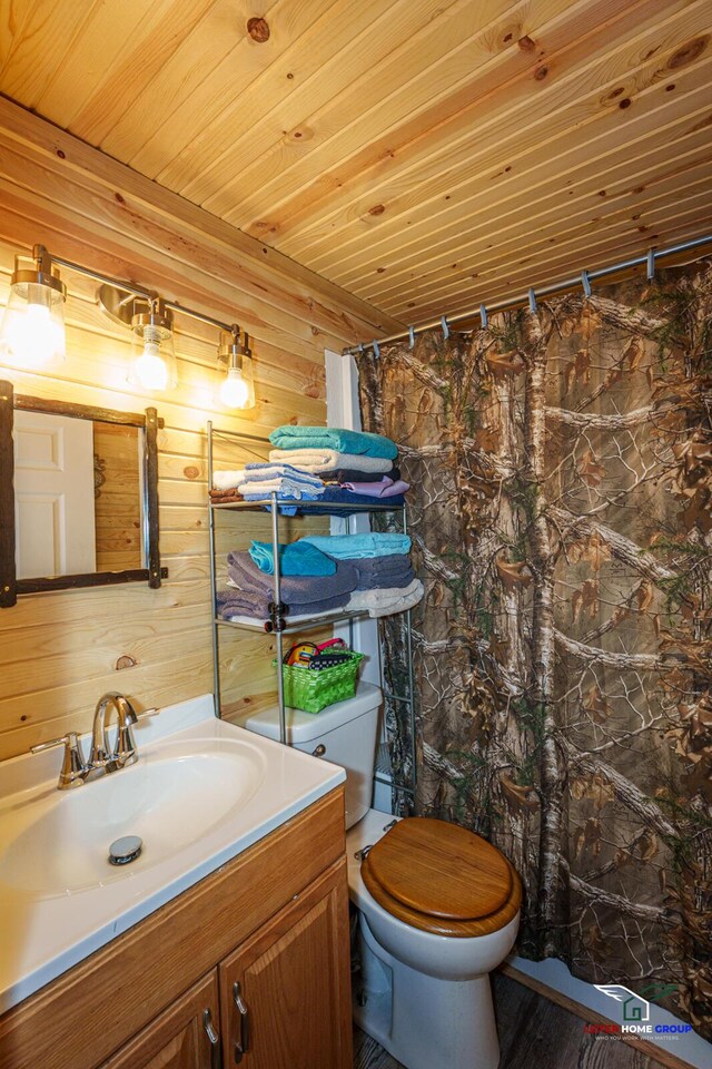 full bath with wooden walls, toilet, wooden ceiling, and vanity