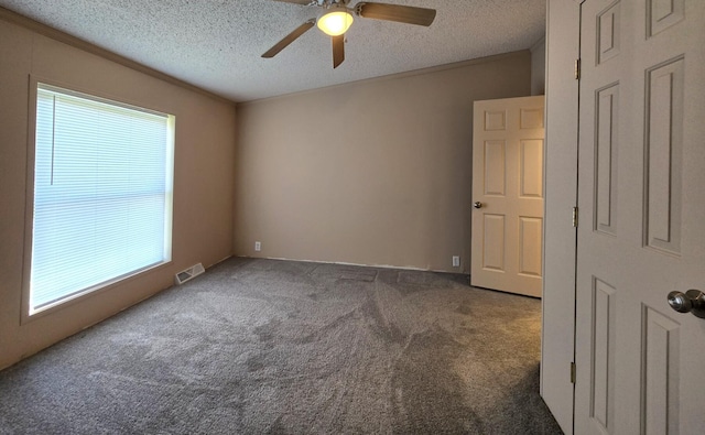 2401 Schippers Ln, Kalamazoo, MI 49048 - empty room featuring ceiling fan, a textured ceiling, visible vents, and carpet