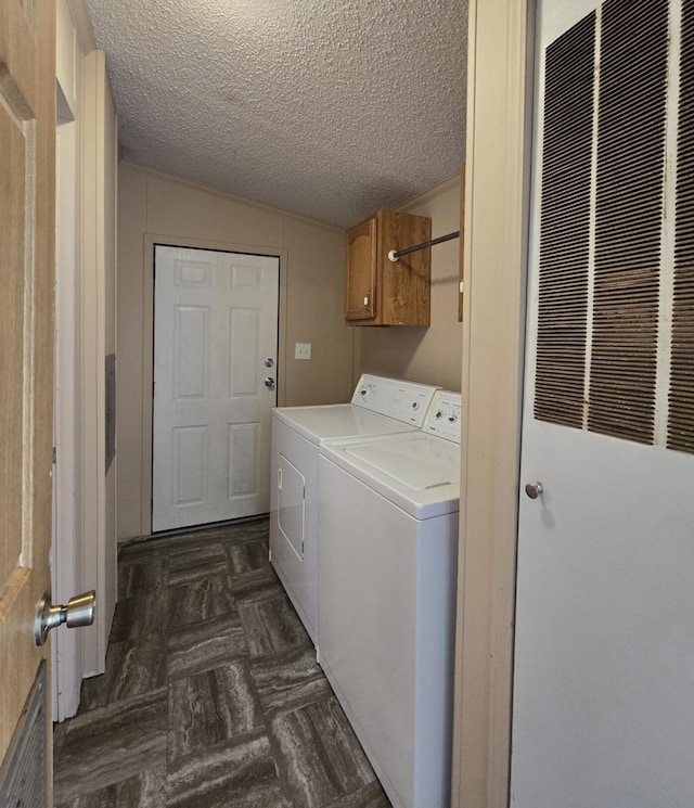 2401 Schippers Ln, Kalamazoo, MI 49048 - clothes washing area featuring separate washer and dryer, cabinet space, a heating unit, and a textured ceiling