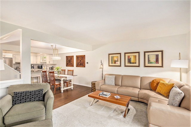 living area featuring dark wood finished floors and baseboards