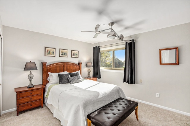 bedroom with light carpet, baseboards, and ceiling fan
