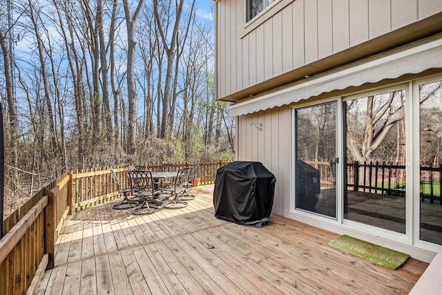 deck with grilling area and outdoor dining space