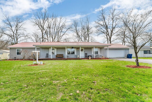 110 Dayton St, Homer, MI 49245 - single story home with concrete driveway, a front lawn, a porch, and a garage
