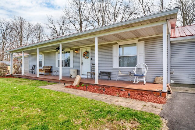 110 Dayton St, Homer, MI 49245 - single story home with a front yard, metal roof, ceiling fan, and covered porch