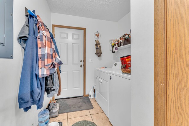 110 Dayton St, Homer, MI 49245 - laundry area featuring washing machine and dryer, a textured ceiling, laundry area, and light tile patterned flooring
