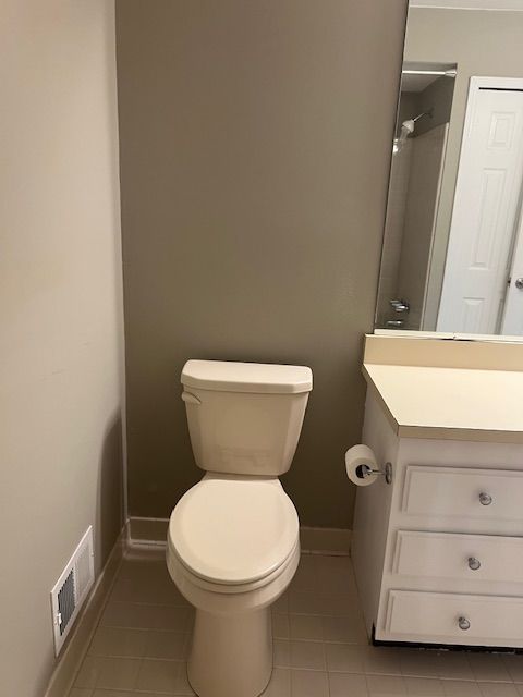 full bath featuring visible vents, baseboards, toilet, tile patterned floors, and vanity