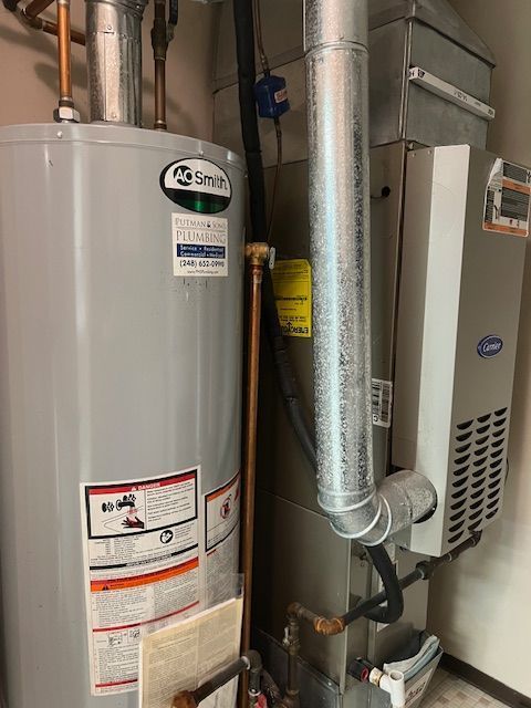 utility room featuring water heater