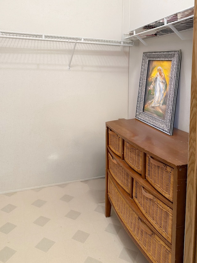walk in closet with tile patterned floors