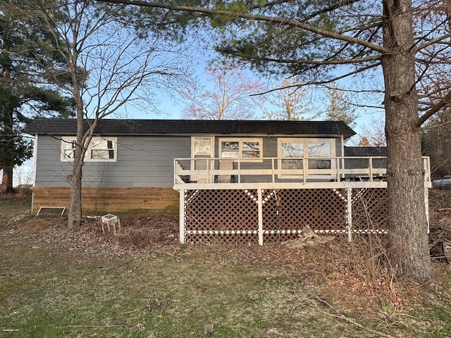 rear view of house featuring a deck