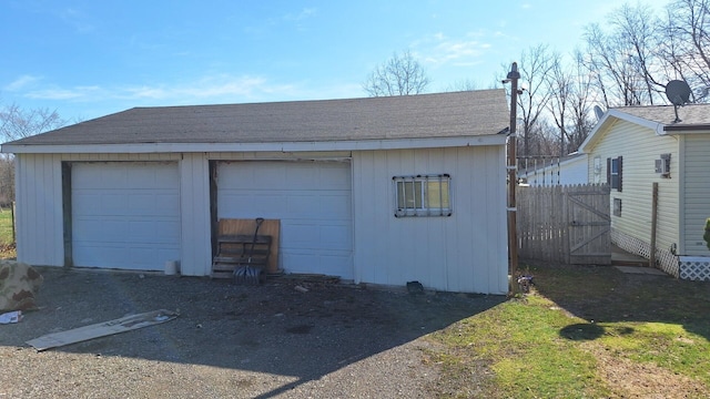 detached garage featuring fence