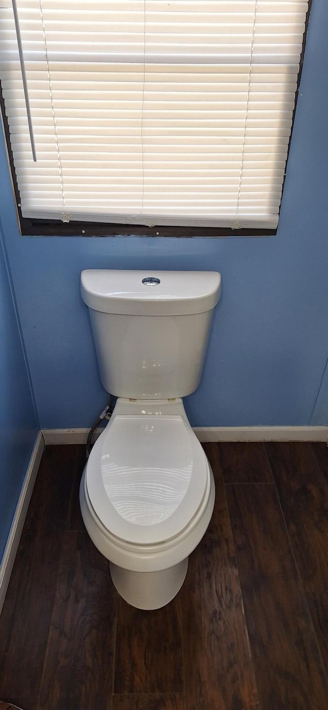 bathroom featuring wood finished floors, toilet, and baseboards