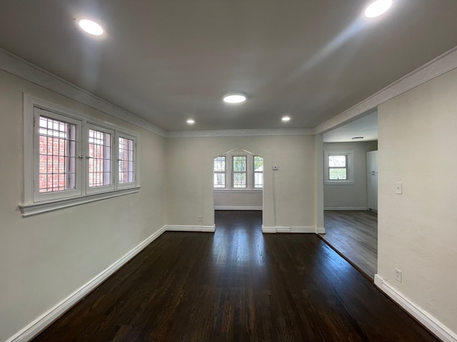 empty room with recessed lighting, baseboards, dark wood-style floors, and ornamental molding