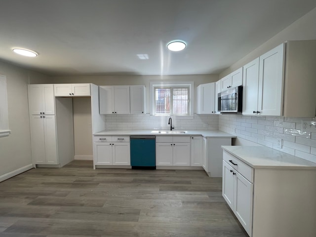 kitchen with a sink, stainless steel microwave, backsplash, and dishwasher
