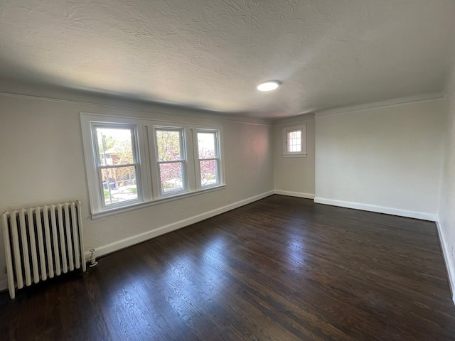 unfurnished room featuring crown molding, radiator, baseboards, and dark wood-style floors