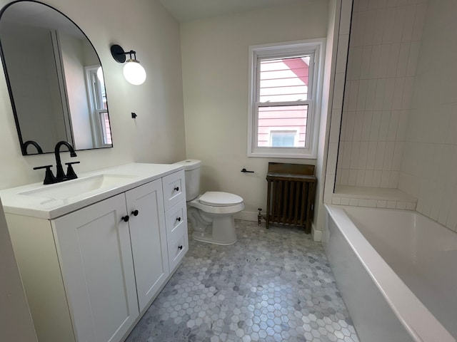 bathroom with vanity, radiator heating unit, and toilet