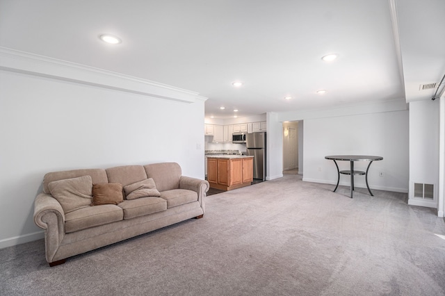 living area featuring crown molding, recessed lighting, visible vents, and light colored carpet