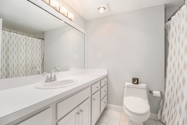bathroom with tile patterned floors, toilet, vanity, and baseboards