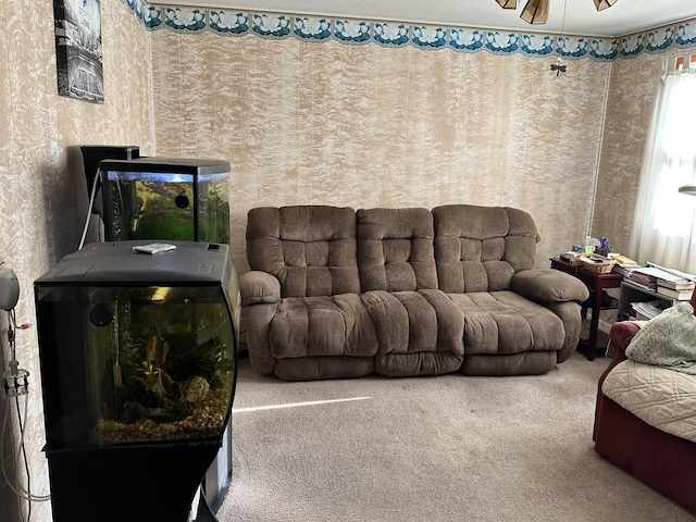 carpeted living area featuring ceiling fan
