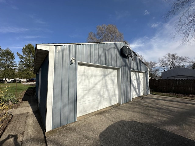 detached garage featuring fence