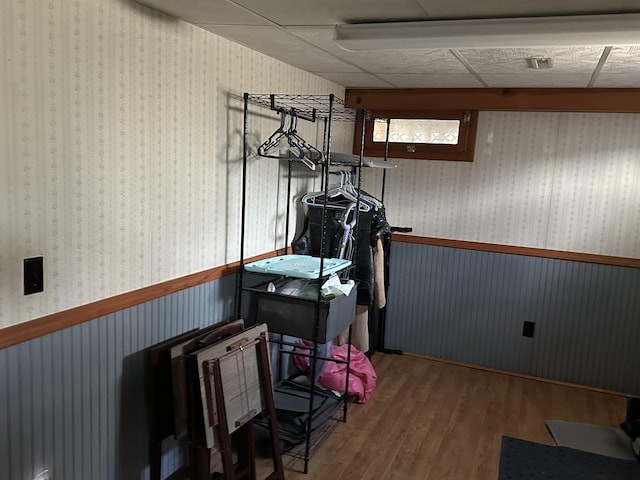 miscellaneous room featuring wainscoting and wood finished floors