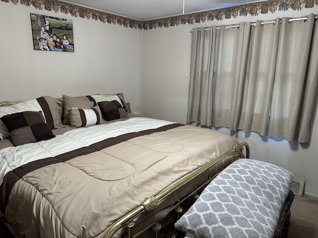 carpeted bedroom featuring a textured ceiling