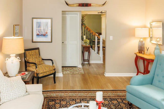 11630 Mcclumpha Rd, Plymouth, MI 48170 - living room featuring stairway, wood finished floors, and baseboards