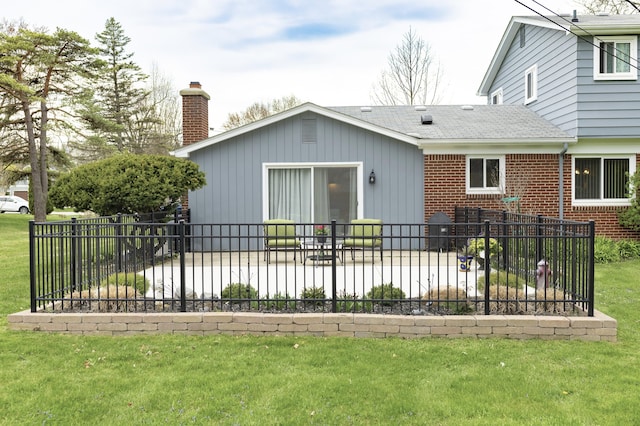 11630 Mcclumpha Rd, Plymouth, MI 48170 - rear view of property featuring a chimney, brick siding, fence, a patio, and a lawn