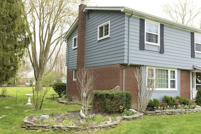11630 Mcclumpha Rd, Plymouth, MI 48170 - view of side of property with brick siding, a yard, and a chimney