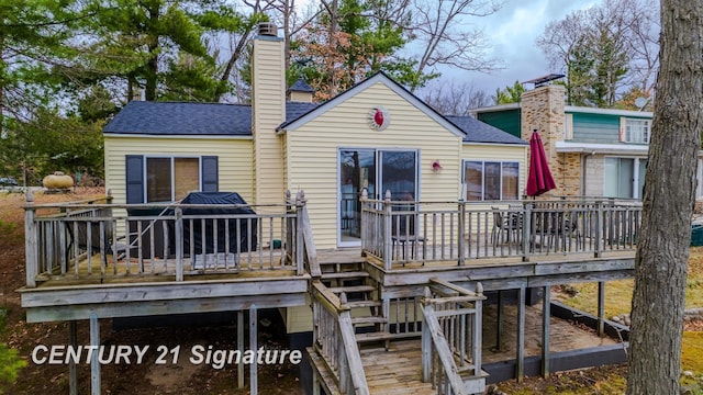 7765 Nicole Dr, South Branch, MI 48761 - back of property with stairway, roof with shingles, a chimney, and a deck