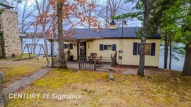 7765 Nicole Dr, South Branch, MI 48761 - back of property with a wooden deck and a chimney
