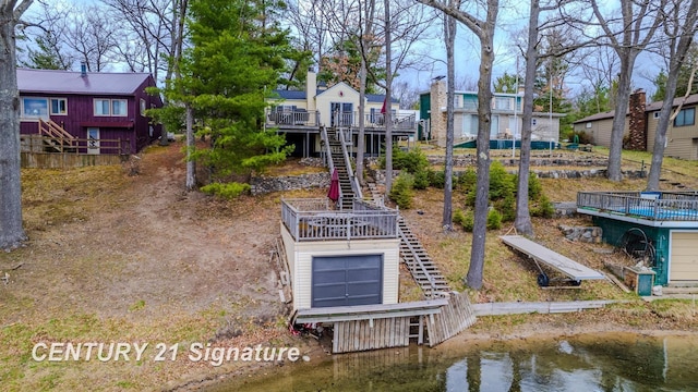 7765 Nicole Dr, South Branch, MI 48761 - view of property's community with stairs and a deck with water view