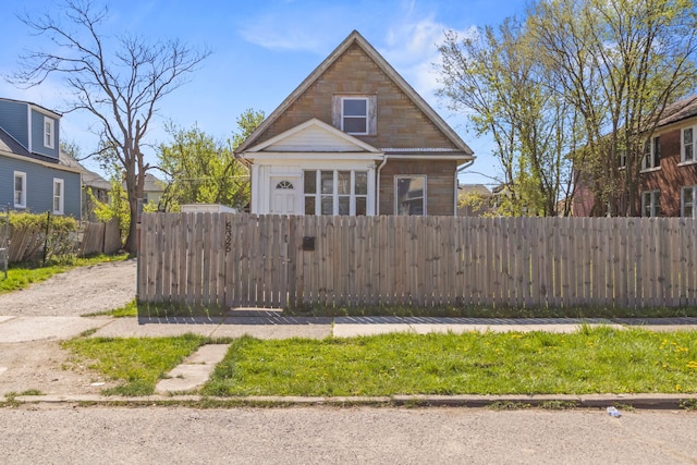 bungalow-style house with a fenced front yard