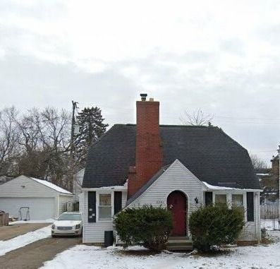 2541 Thomas St, Flint, MI 48504 - view of front of house featuring a chimney, an outdoor structure, and a garage