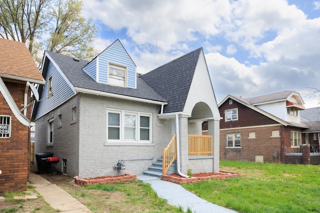 15100 Washburn St, Detroit, MI 48238 - view of front facade with roof with shingles, brick siding, and a front lawn