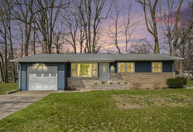 view of front of house with driveway, a garage, a front lawn, and stone siding