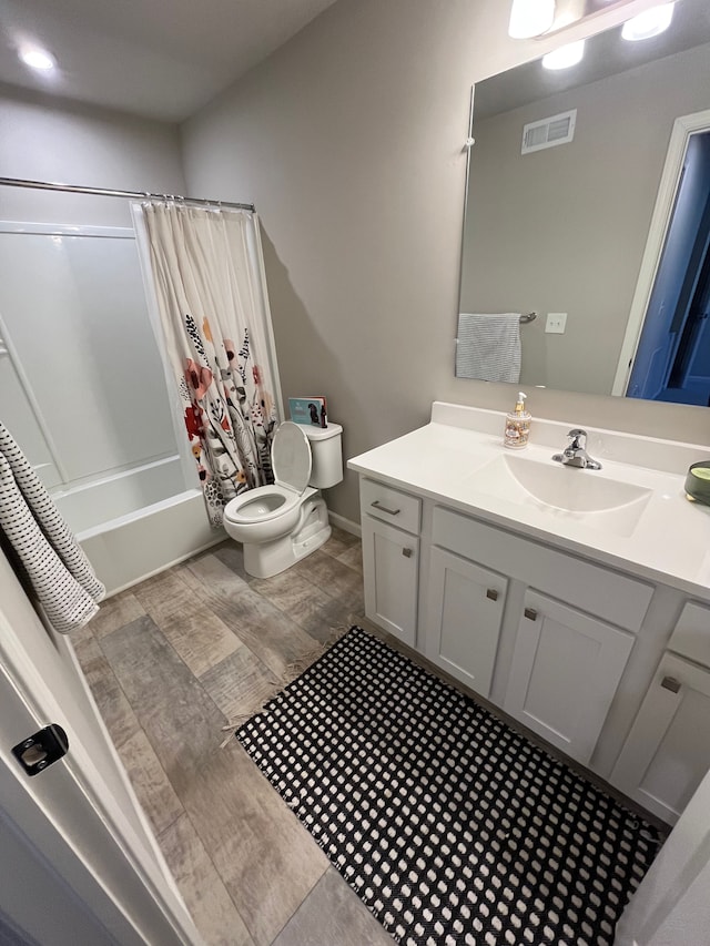 bathroom featuring visible vents, shower / bath combo, toilet, and vanity