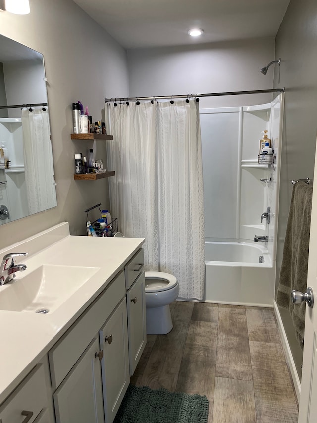 full bath featuring vanity, wood finished floors, toilet, recessed lighting, and shower / tub combo