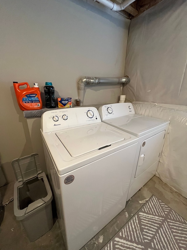 washroom with independent washer and dryer and laundry area