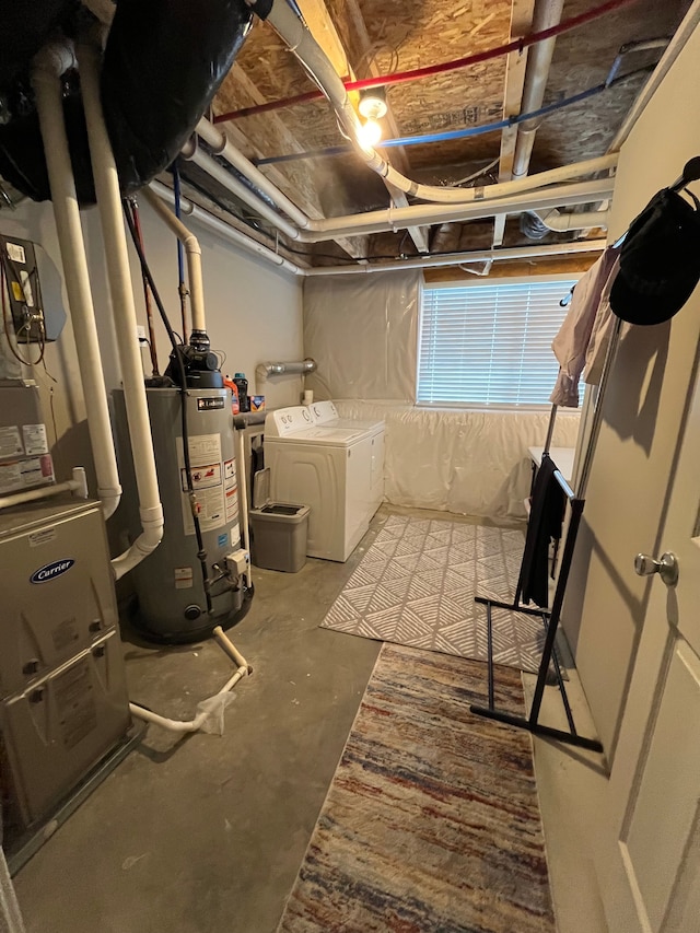 below grade area featuring water heater and washer and dryer