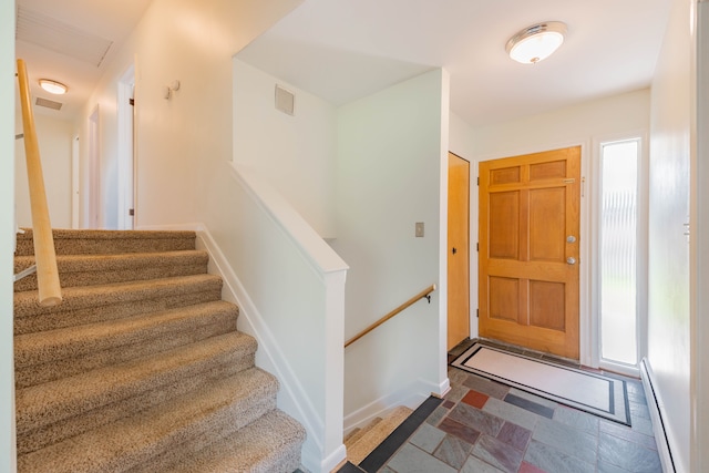 entrance foyer featuring stairway, a baseboard radiator, and visible vents