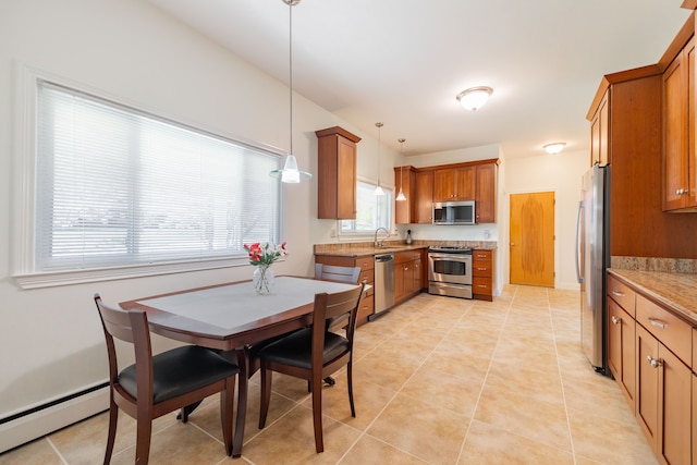 dining room with a baseboard heating unit and light tile patterned floors